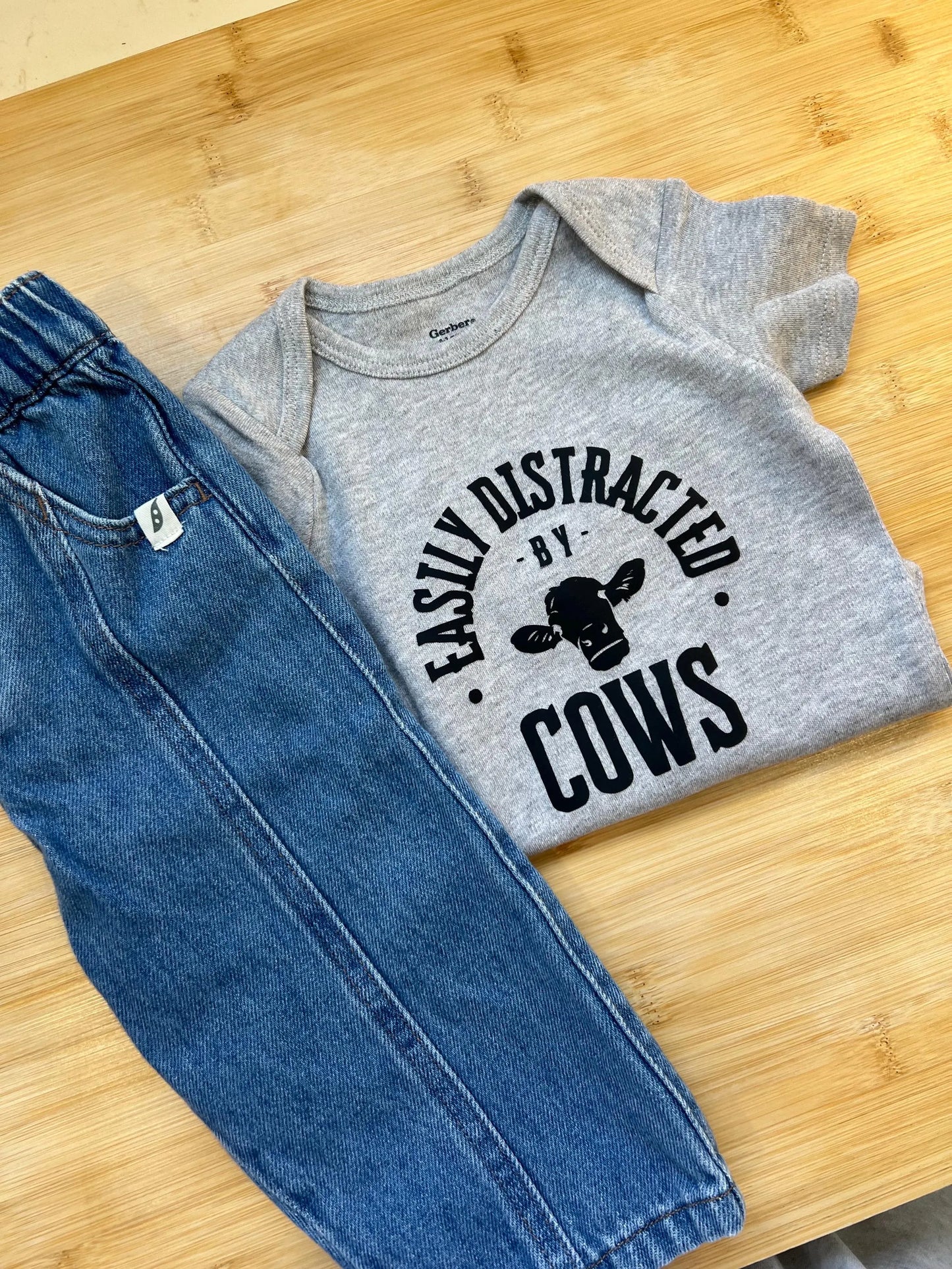 Easily Distracted by Cows Baby Onesie